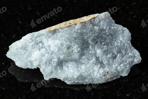 Preview: sample of raw jadeite rock on black granite