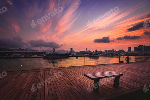 Preview: Sunset over a wooden platform surrounded by the ships of the harbor