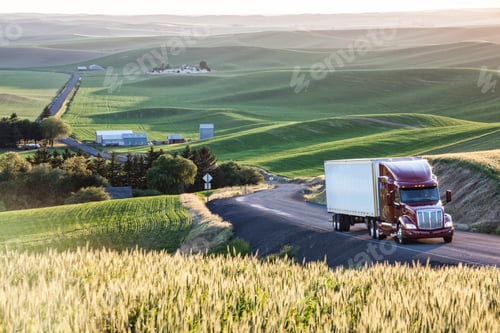 Preview: commercial truck driving though wheat fields of eastern Washington, USA at sunset.