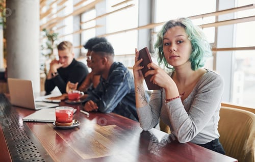 Preview: Alternative girl with green hair is sitting against group