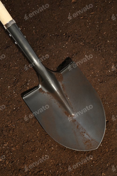 Preview: Metal shovel on fertile soil, top view. Gardening tool