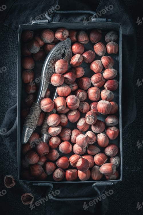 Preview: Pile of hazelnuts on dark table. Quick and good snack.