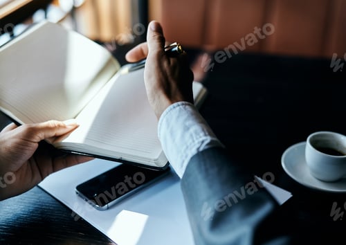 Preview: businesswoman in a cafe with a book on the table documents a cup of coffee work lifestyle