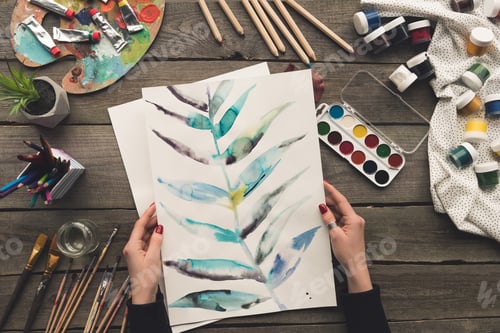 Preview: Watercolor Painting of Botanical Leaves on Wooden Table