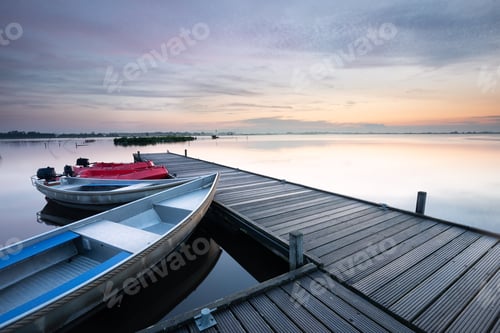 Preview: boat at pier on big lake during sunrise