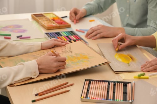 Preview: Artists drawing with soft pastels and pencils at table, closeup