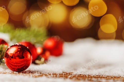 Preview: Christmas bauble on snowy wooden table. Christmas concept