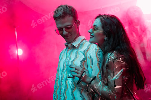 Preview: smiling girl holding weed in plastic zipper bag near man in nightclub