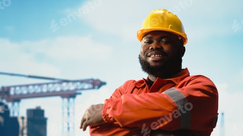 Preview: Portrait of smiling offshore rig engineer speaking in walkie talkie