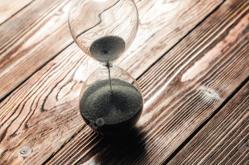 Preview: Modern hourglass on wooden background