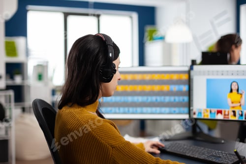 Preview: Focused retoucher specialist working at computer in creative office