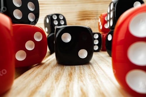 Preview: Red and black dice cubes on wooden background