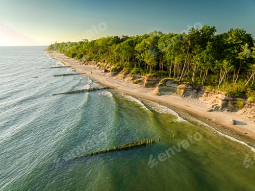 Preview: Baltic Sea and narrow beach in summer at sunset.