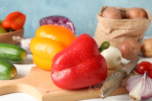 Preview: Vegetables, board and knife on white wooden background, close up
