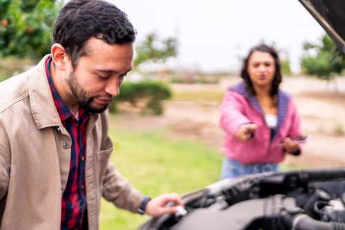 Preview: Couple checking car engine after breaking down on roadside
