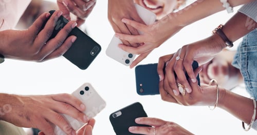 Preview: Hands, phone and communication with friends standing in a huddle or circle from below for networkin