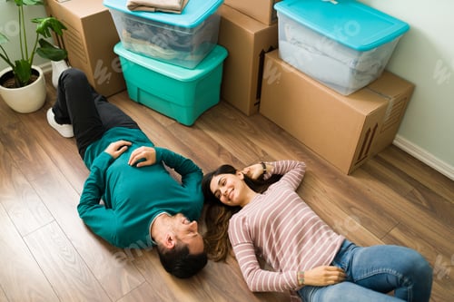 Preview: Tired boyfriend and girlfriend lying and resting on the floor