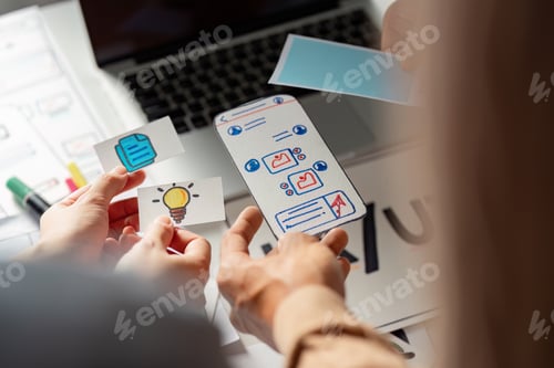Preview: Creative team collaborating on UX UI design with wireframes and ideas.