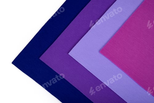 Preview: Colorful thick fabric sheets in purple and pink tones on a white background in a triangular shape.