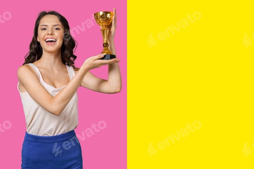 Preview: Winner holding a trophy in front of a colorful background during a celebration event