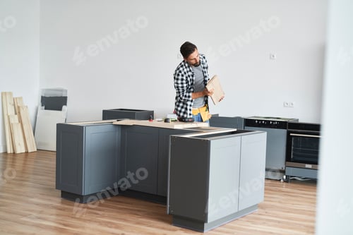 Preview: Carpenter assembling new kitchen furniture