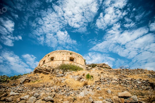 Preview: Low-angle shot of the fortress against the background of a blue cloudy sky. Lindos, Greece.