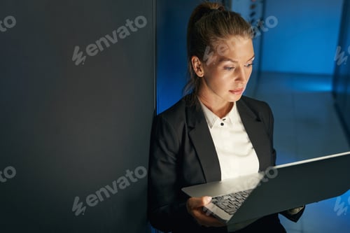 Preview: Engineer businesswoman works in network server room