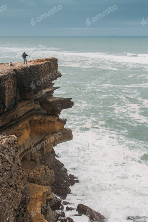 Preview: Fisherman fishing on a big cliff