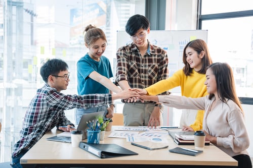Preview: Young colleagues having great business conversations in a modern coworking office. Teamwork concept.