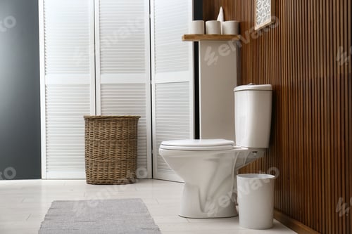 Preview: White toilet bowl near wooden wall in modern bathroom interior