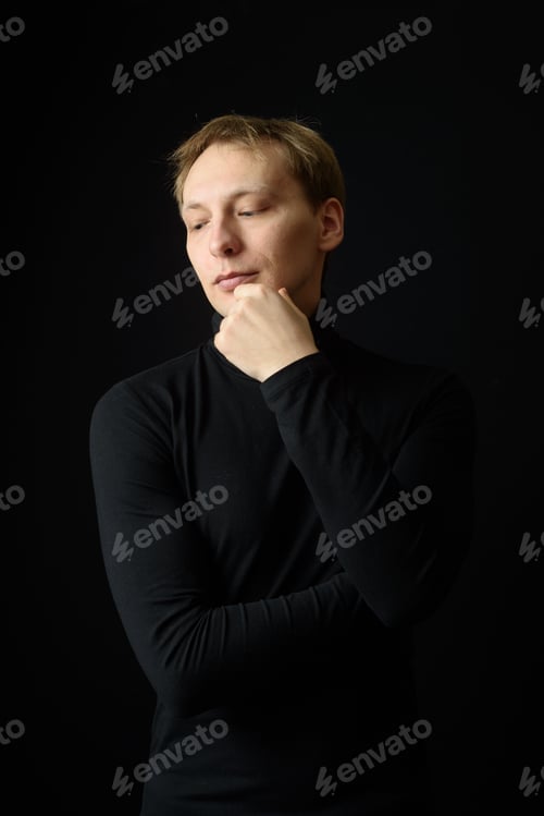 Preview: Close up portrait of a young man in a white shirt and black tie.