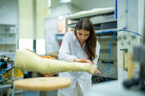 Preview: Orthopedic technician adjusting prosthetic leg for disabilities people