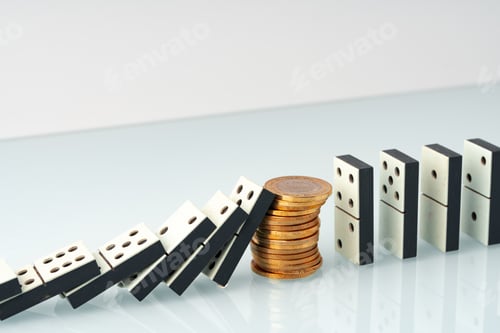 Preview: Domino tiles in a row and coins close up. Financial crisis concept