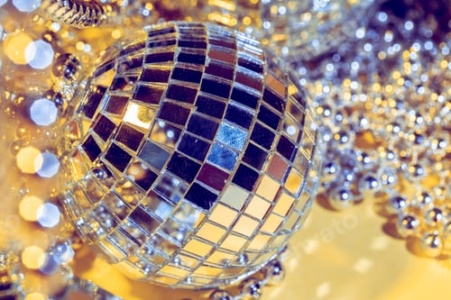 Preview: disco ball concept. Isolated on yellow background