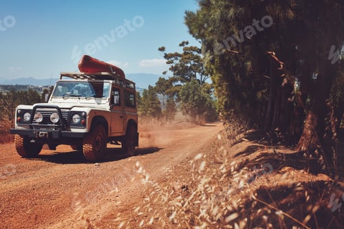 Preview: Car driving off road with canoe