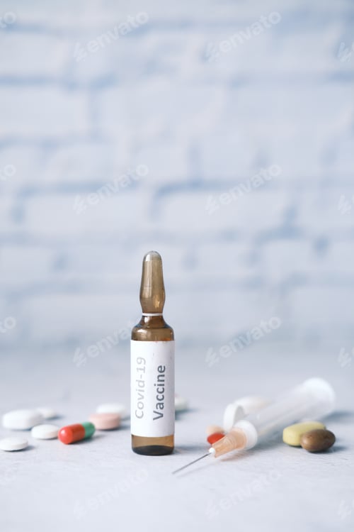 Preview: Close up of coronavirus vaccine and syringe on table