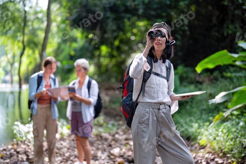 Preview: Backpack tourist travel outdoor adventure bird study using binoculars looking and record to book
