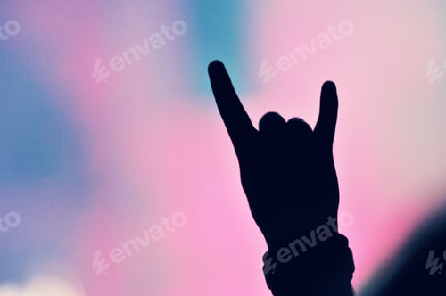 Preview: Silhouette of hands on a concert in front of bright stage lights