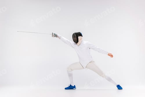 Preview: Man wearing fencing suit practicing with sword against gray