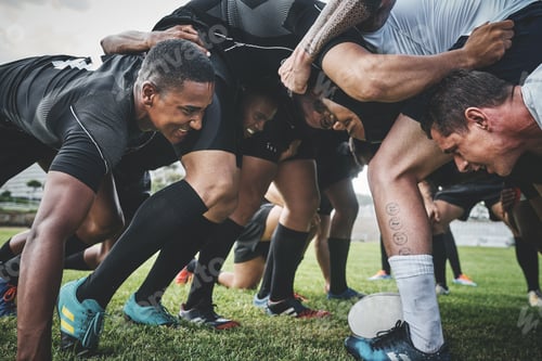 Preview: Low angle shot of two young rugby teams competing in a scrum during a rugby match on a field