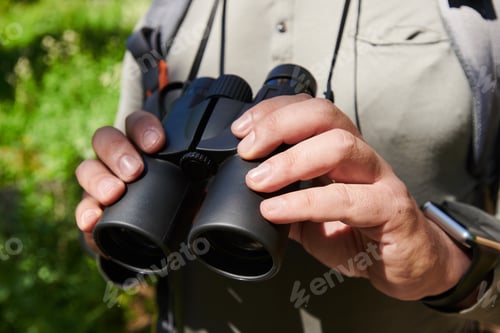 Preview: Man with binoculars outdoors