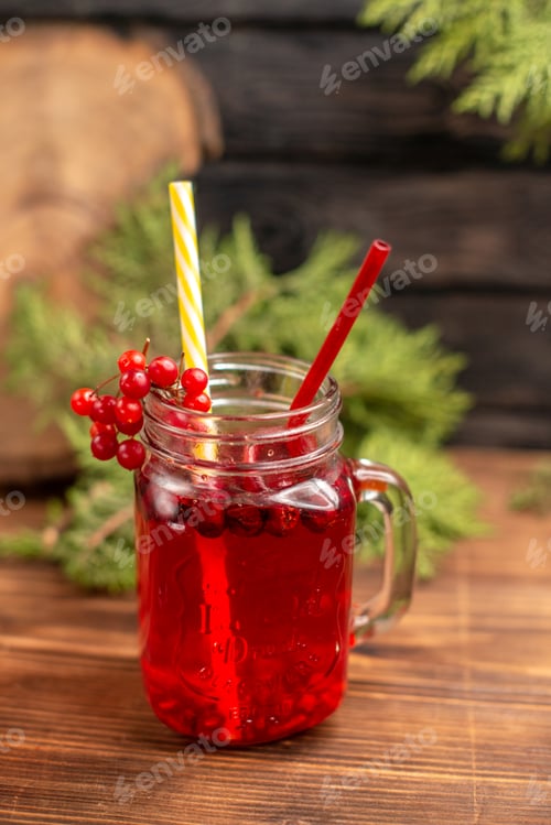 Preview: Top view of natural organic fresh currant juice in a bottle served with tubes on a wooden table