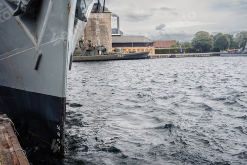 Preview: Bow of an old military ship, chained to the port, steel plates.