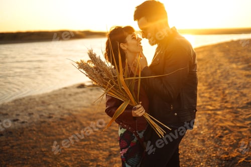 Preview: Enjoying time together. Stylish and loving couple enjoying each other by the sea.