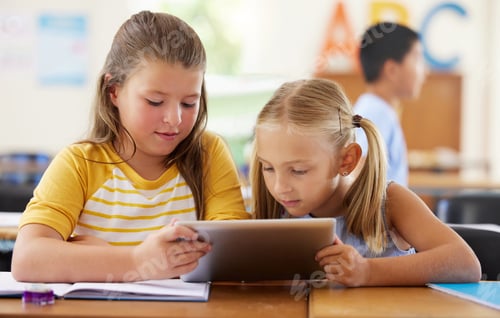 Preview: Its her favourite lesson. Shot of two girls using a tablet in a classroom.