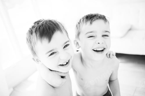 Preview: Identical twins laughing together having fun