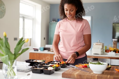 Preview: Woman Preparing Batch Of Healthy Meals At Home In Kitchen