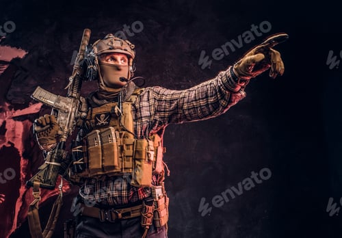 Preview: Special forces soldier in camouflage uniform holding an assault rifle with a laser sight