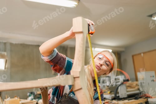 Preview: Carpenter working with wooden plank in workshop. making a furniture from wood
