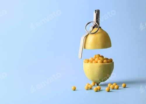 Preview: Creative vitamin concept. A handmade pomegranate in the form of a lemon with scattered dragees.